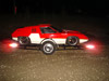 Red and white sports car on a trailer
